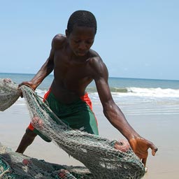 Fisherman close up on Lumley beach pulling in their net, Freetown, Sierra Leone.
