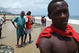 Fishermen pull their net in on Lumley beach.