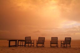 4 Deck chairs on beach, twilight.