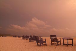 long Row of Deck chairs on beach, dusk.