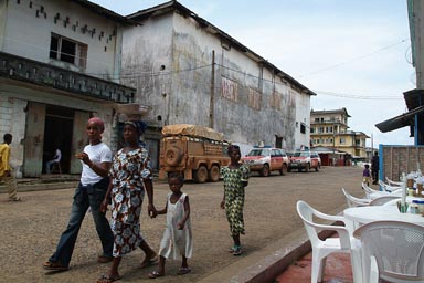 Sophie's spot African mother, girls and daughters walk by, Uninted Nations Land Cruisers.