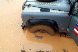 Mud hole full of water, 6x6 Land Rover Defender stuck near Buchanan, Liberia.