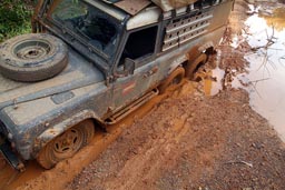 Liberia, 6x6 Land Rover Defender, stuck in mud hole, muddy roads.