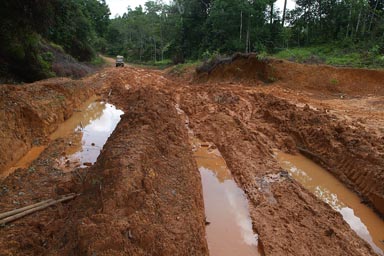 6x6 6 wheeled Land Rover Defender, inspecting a muddy strech of road, Greeville to Zwedru, Liberia.