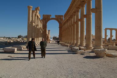Decumanus, collonades, Palmyra, men walking. Decumanus, collonades, Palmyra, men walking.