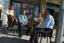 Ar-Raqqah, men, laughing, sitting in street, Syria.