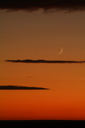 New moonset, desert, Syria, Orange sky, black clouds.
