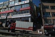 Steeply sloped street and truck in Istanbul, small businesses district.