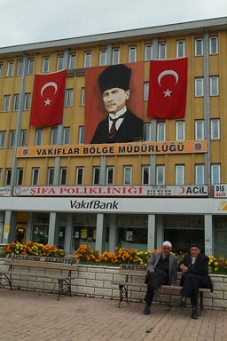 Kastamonu, two old turkish muslims in front of Ataturk posters and Turkish flags on end of Ramadan.