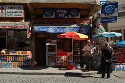 Man reading paper in front of shop. Giresun, Trabzon.