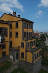 Another yellow Ottoman building looking down the ravine in Trabzon, Turkey.