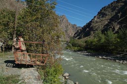 Old man works new robes for cable people carriage, over Coruh river, Turkey.