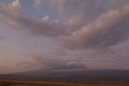 Mount Ararat, dusk, violet colors, haze, a few clouds.