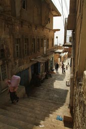 Steps and woman and load, Mardin Turkey.