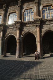 Ulu Chamii, old man sitting in courtyard.