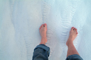 Feet on white chalky soil, Pamukkale.