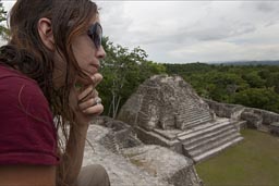 3 relgious temples on top of Canaa. C. is contemplating the greatness of the Caracol pyramid structure in the Maya mountains in Belize.