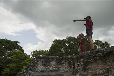 Some houler monkey is spotted. C. and boys are watching from pyramid, Xunantunich.