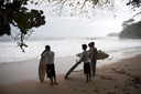 Brazillian surfers watch the waves on lone beach, Caribbean Costa Rica.