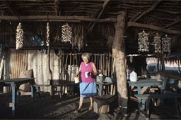 Old woman in beach cafe brings me coffee, morning in El Zonte, El Salvador.