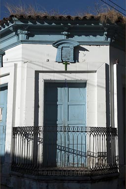 House in Suchitoto, white paint, light blue wooden door, black banister. El Salvador.