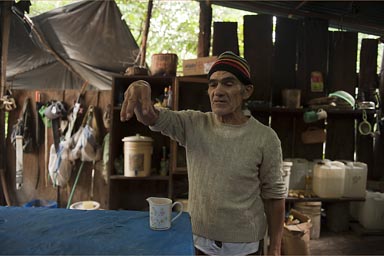 Explains plant use, knowledgeable old guard at El-Mirador site, Peten Guatemala. 