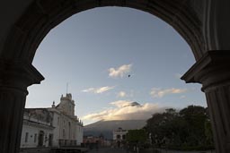 Volcan de Agua, Antigua. Guatemala. A bird flies, morning blue skies, the usual clouds.