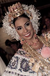 She is the queen Las Tablas 2012. Static smile, gold and crown and tembleques, pollera dress.