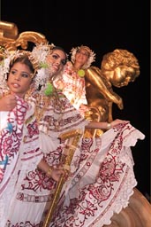 Queens on a queens cart, and golden statue in back. Las Tablas, Carnival..