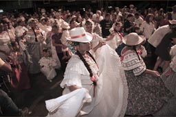 Panamanian woman in carnival procession wearing traditional pollera dress and hat, a tuna, Las Tablas, Panama.