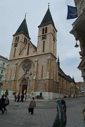 Cathedral, veiled women, European flag, Sarajevo.