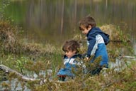 Boys at lake in woods.