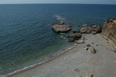 Greece, pebbles beach, blue sea till horizon.
