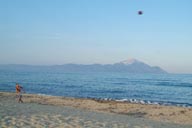 Mount Artos, Chalkidikim seen from Sarti beach on Sithonia, with Football player on Sarti beach.