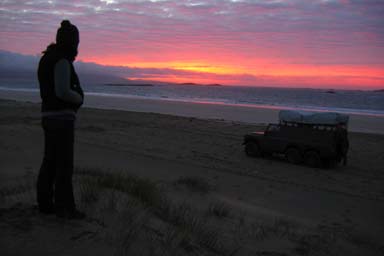 Heid and sunset and landrover on beach