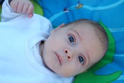 David on blue blanket, eyes wide open.