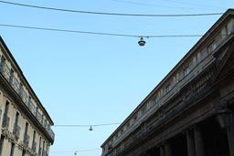 Verona, Palazzos left right, blue evening sky, street lights.