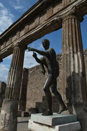 Pompeii, statue, columns, blue sky.