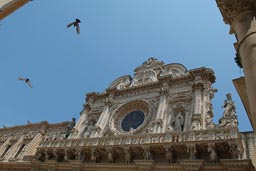 Lecce, Puglia, Santa Croce Basilica, birds and blue sky.