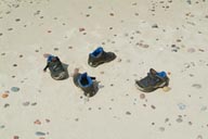 Childrens shoes abandoned on beach.