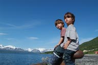 Twins on pier, Lyngen in back.