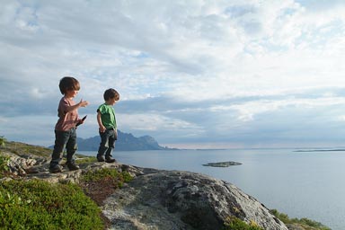 On top of cliff, late sun, boys in Norway.