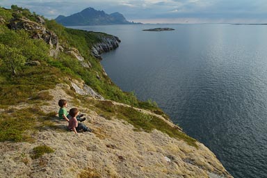 Sitting on soft moss, staring at fjord in late sun.