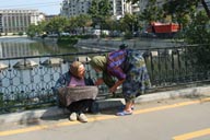 Bucharest, 2 old women on bridge.