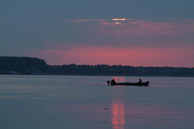 Sunrise over Danube, Fishing boat. Romania.