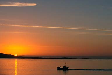 Cutter and sunrise over the sea