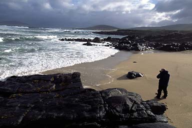 A photographer is taking pictures of the raging sea