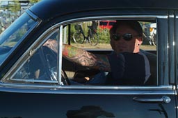 Tattooed arm. Vintage American car.