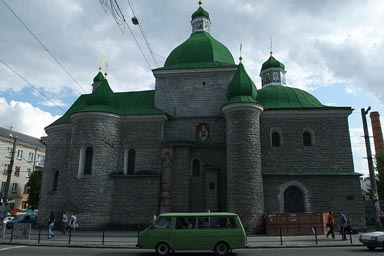Green Cupola on orthodox church in Ternopil, Green old van in front. Ukraine.