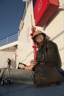 C. reading book opn Baja Ferry.